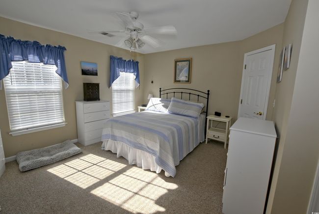 Carpeted bedroom with ceiling fan | Image 17