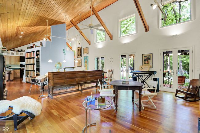 Large living room with French doors, high vaulted ceiling, plenty of natural light, Cherry hardwood floors and a ceiling fan | Image 4