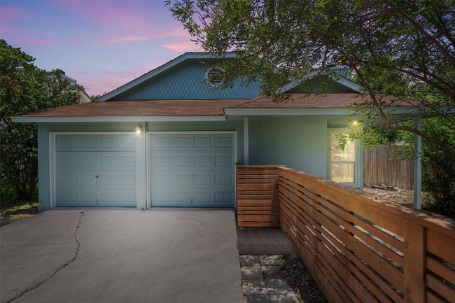 View of front of house with driveway, roof with shingles, and an attached garage | Image 32