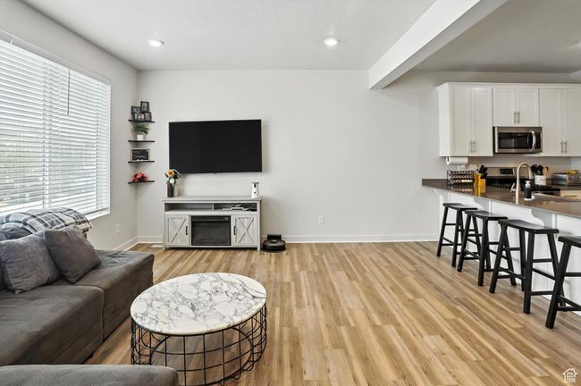 Living area with brand new light wood-style LVP flooring and recessed lighting | Image 7