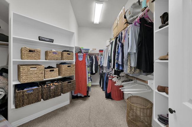The expansive walk-in closet. To the left, additional storage goes behind the shelving. Perfectly organized — it practically does the tidying for you! | Image 22