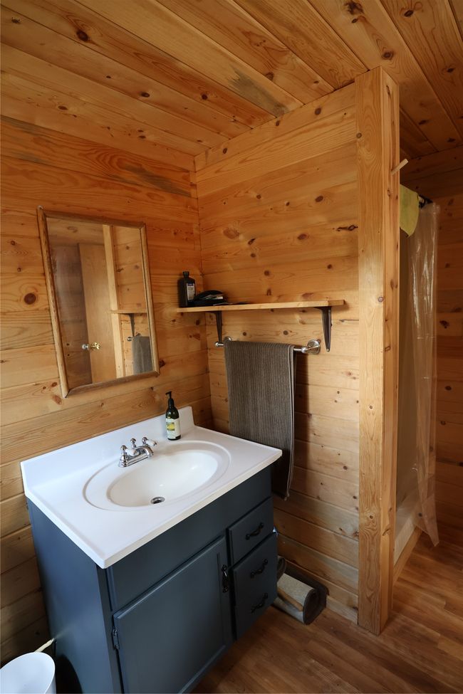 Bathroom featuring vanity, wood finished floors, curtained shower, wooden walls, and wood ceiling | Image 44