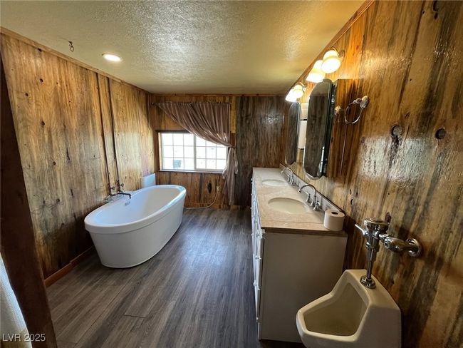 Bathroom featuring wooden walls, wood finished floors, and a sink | Image 11