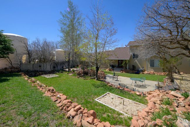 View of yard featuring a patio area and fence | Image 55