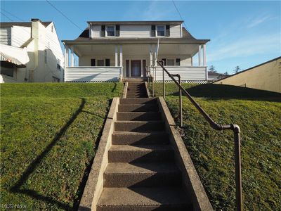 View of front of property featuring covered porch and a front lawn | Image 1