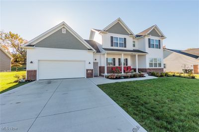 Craftsman-style house with a porch and a front yard | Image 3