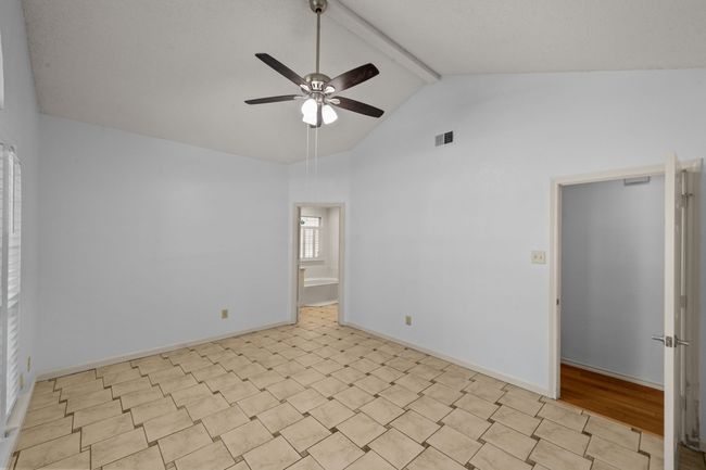 Empty room with a vaulted ceiling, beam & fan | Image 24
