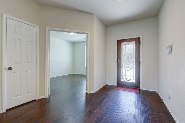 Foyer entrance featuring dark wood finished floors and baseboards | Image 8