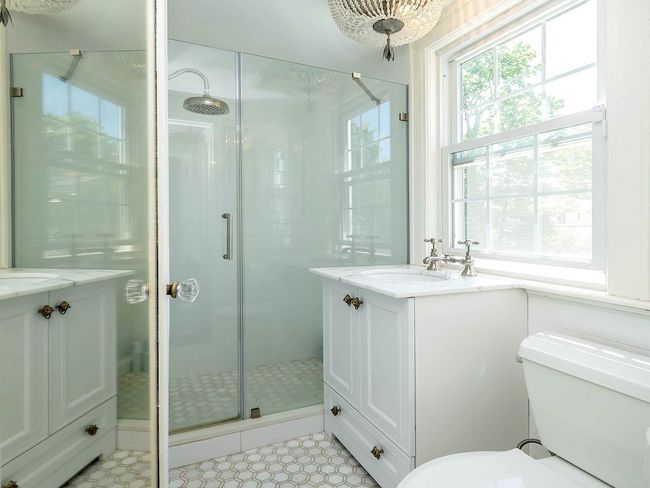 Bathroom with vanity, a shower stall, toilet, and tile patterned flooring | Image 17