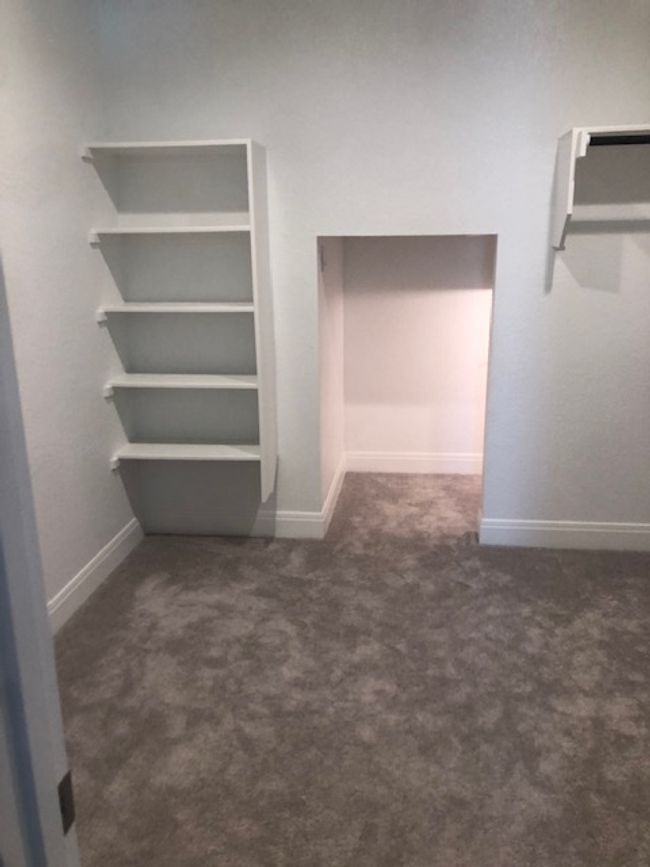 Walk in closet with carpet floors | Image 15