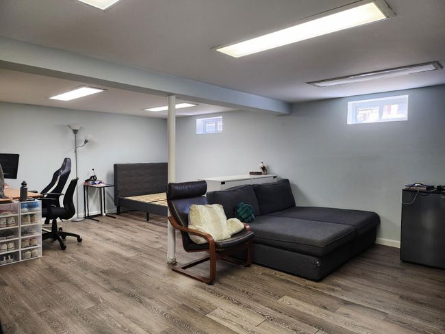 Living area with baseboards and wood finished floors | Image 13