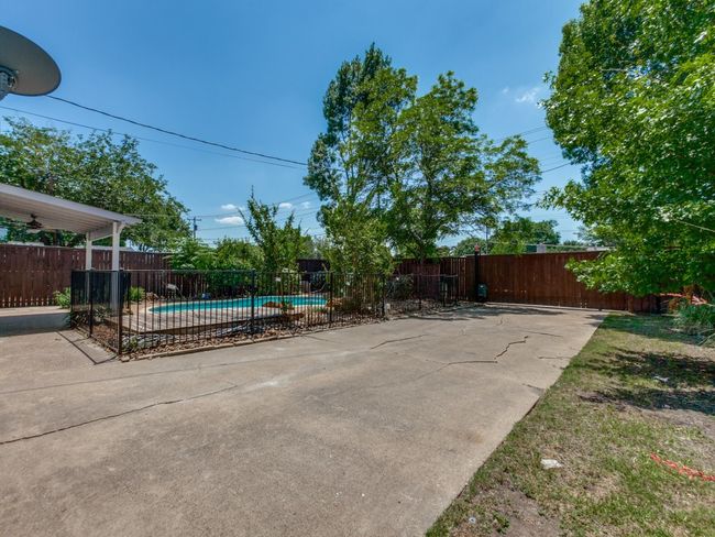 View of pool with a fenced backyard and a patio area | Image 25