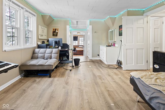 bedroom with baseboards and wood finished floors | Image 11