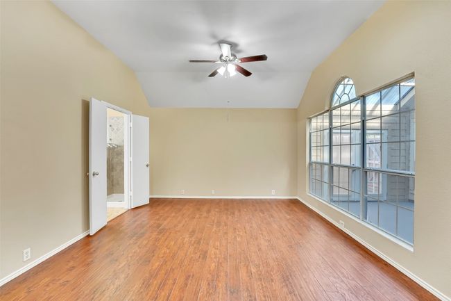 Unfurnished room featuring wood-type flooring, ceiling fan, and vaulted ceiling | Image 29