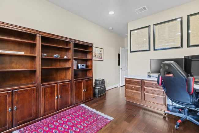 Office space with dark wood-type flooring and baseboards | Image 21