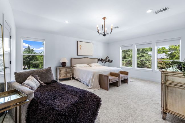 Large Master bedroom lots of windows with roll down shades. Features 2 closets | Image 23