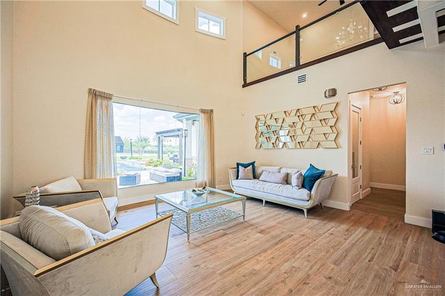 Living area featuring porcelain floors and a towering ceiling | Image 7