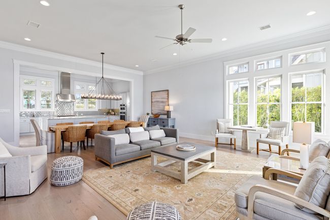 Living room featuring visible vents, light wood-style floors, crown molding, and ceiling fan with notable chandelier | Image 8