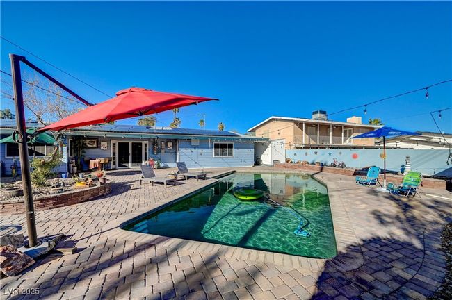 Back of house with a patio, a fenced backyard, and a sunroom | Image 24