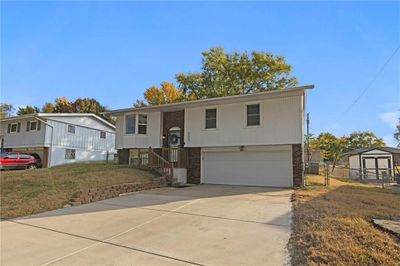 Split foyer home featuring a front lawn and a garage | Image 3