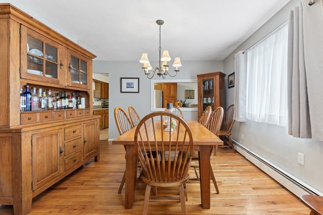 Dining area with light wood finished floors, and chandelier | Image 10