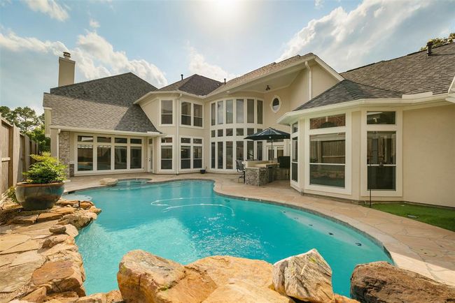 Whether you're diving in for an afternoon swim, enjoying dinner under the covered area, or soaking in the peaceful ambiance by the water, this outdoor space is built for relaxation, connection, and year-round enjoyment. | Image 45