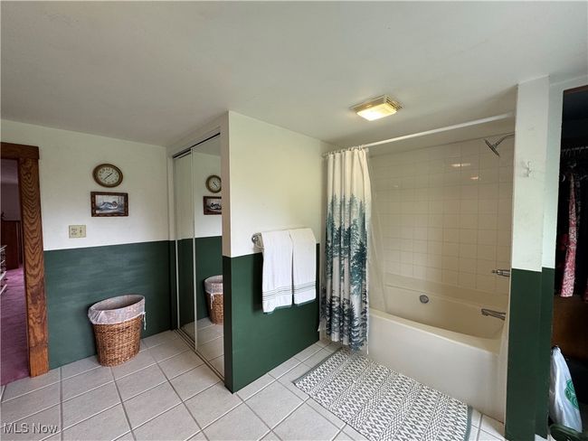 Full bath with tile patterned floors and shower / bath combo | Image 32