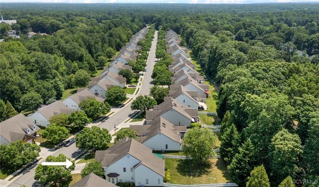 Aerial perspective of suburban area featuring a heavily wooded area | Image 48