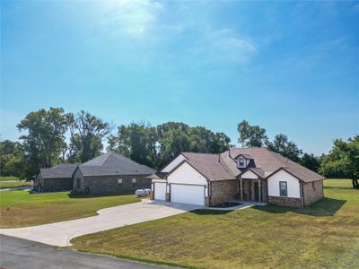 French country style house with a garage and a front yard | Image 2