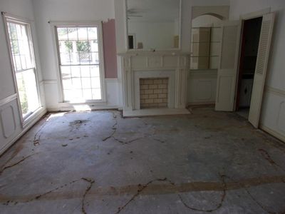 Unfurnished living room with a wealth of natural light and ceiling fan | Image 3