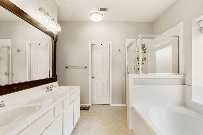 Primary bathroom with double sinks and tub and shower | Image 10