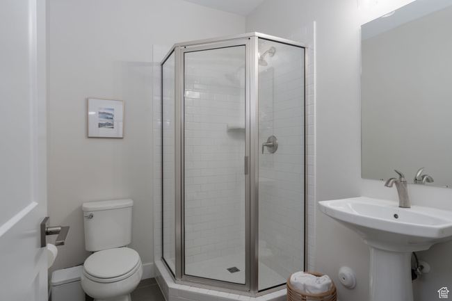 Bathroom featuring a shower stall, toilet, and a sink | Image 37