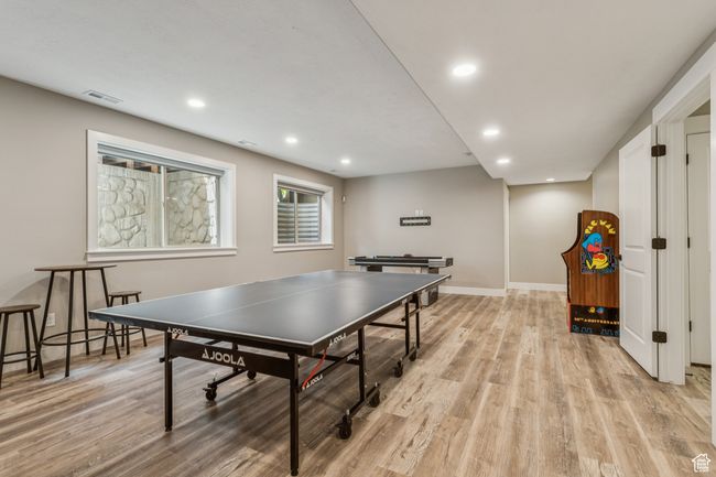 Recreation room featuring light wood-type flooring and recessed lighting | Image 56