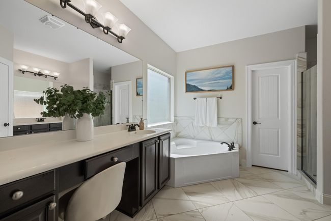 Bathroom featuring a bath, visible vents, a shower stall, vanity, and marble finish floor | Image 8