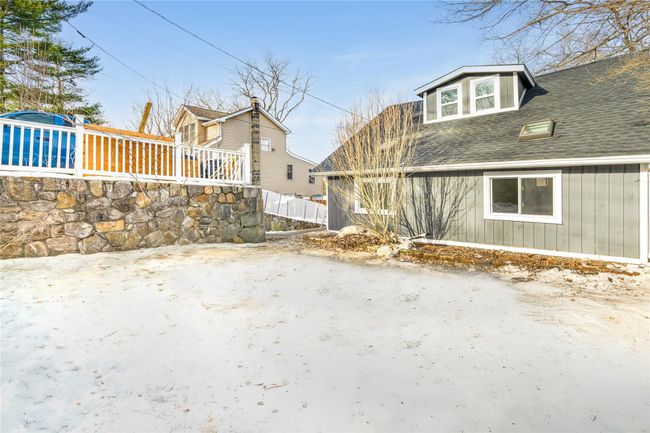 View of home's exterior featuring roof with shingles and fence | Image 18