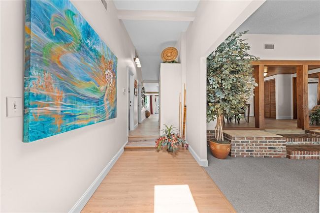 Main Home - This view is coming out of the Primary Bedroom with the Family Room just off to the right. | Image 44