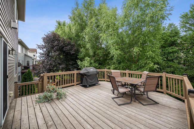 Deck is surrounded by mature trees. | Image 30