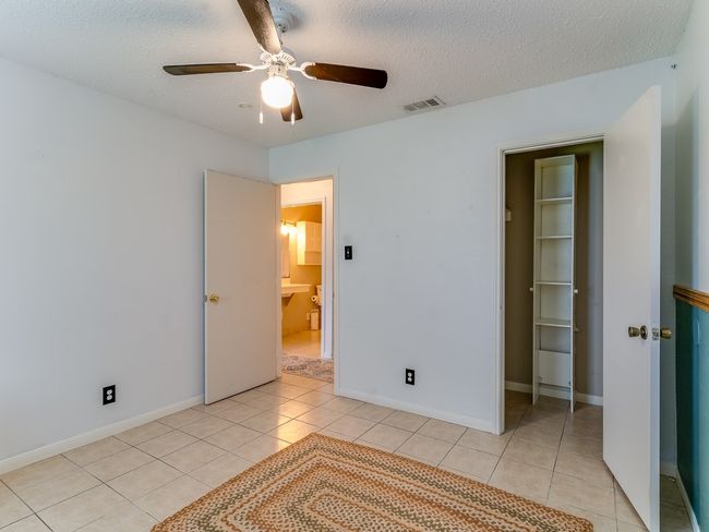 Spare room featuring light tile patterned floors, a ceiling fan, and a textured ceiling | Image 20