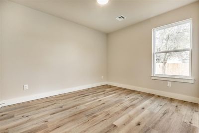 Empty room featuring light hardwood / wood-style floors and a wealth of natural light | Image 3