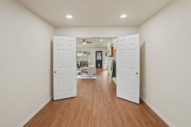 Located just off the living room, this front bedroom features double doors—perfect as a guest room, home office, or flex space. 9349 Bernoulli Dr., Austin, TX 78748 | Image 24