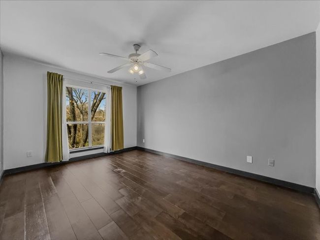 Upstairs bedroom with ceiling fan and dark hardwood / wood-style flooring | Image 19