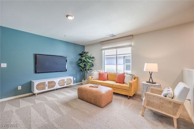 Photo is representational only; actual home finishes may vary. Carpeted living room with baseboards | Image 28