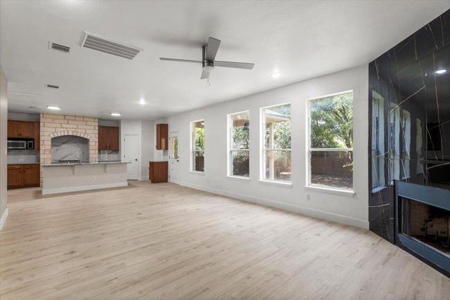 Unfurnished living room with light wood-type flooring, recessed lighting, and ceiling fan | Image 7