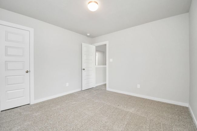 Generously sized secondary bedrooms featuring spacious closets, soft and inviting carpeting underfoot, large windows allowing plenty of natural light, and the added touch of privacy blinds for your personal retreat. | Image 30