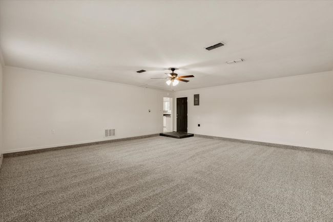 Carpeted spare room with ornamental molding and ceiling fan | Image 12