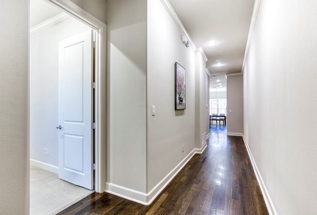 Entry with hallway to primary suite and living area. | Image 4