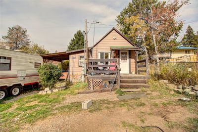 Rear view of property featuring a wooden deck | Image 1