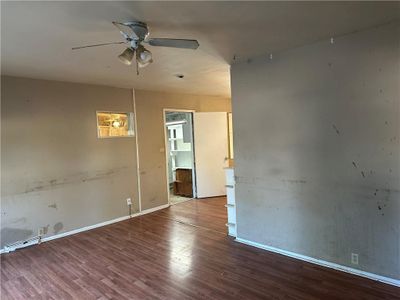 Living room featuring ceiling fan and hardwood / wood-style flooring | Image 3