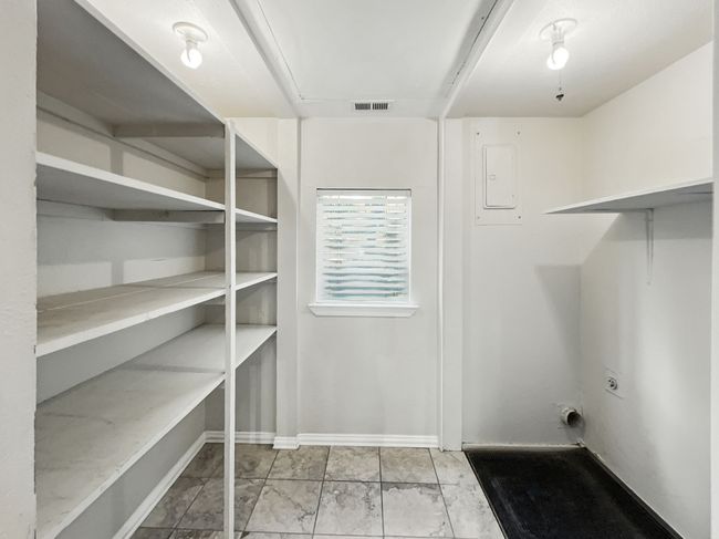 Laundry area with electric panel and baseboards | Image 5