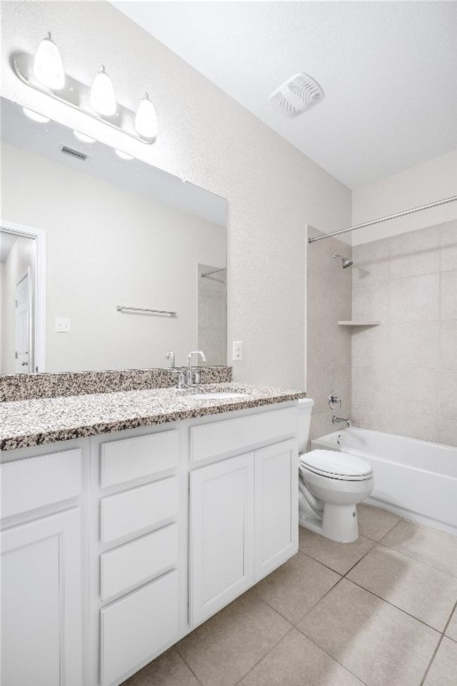 Bathroom featuring vanity, tile patterned floors, and shower combination | Image 32